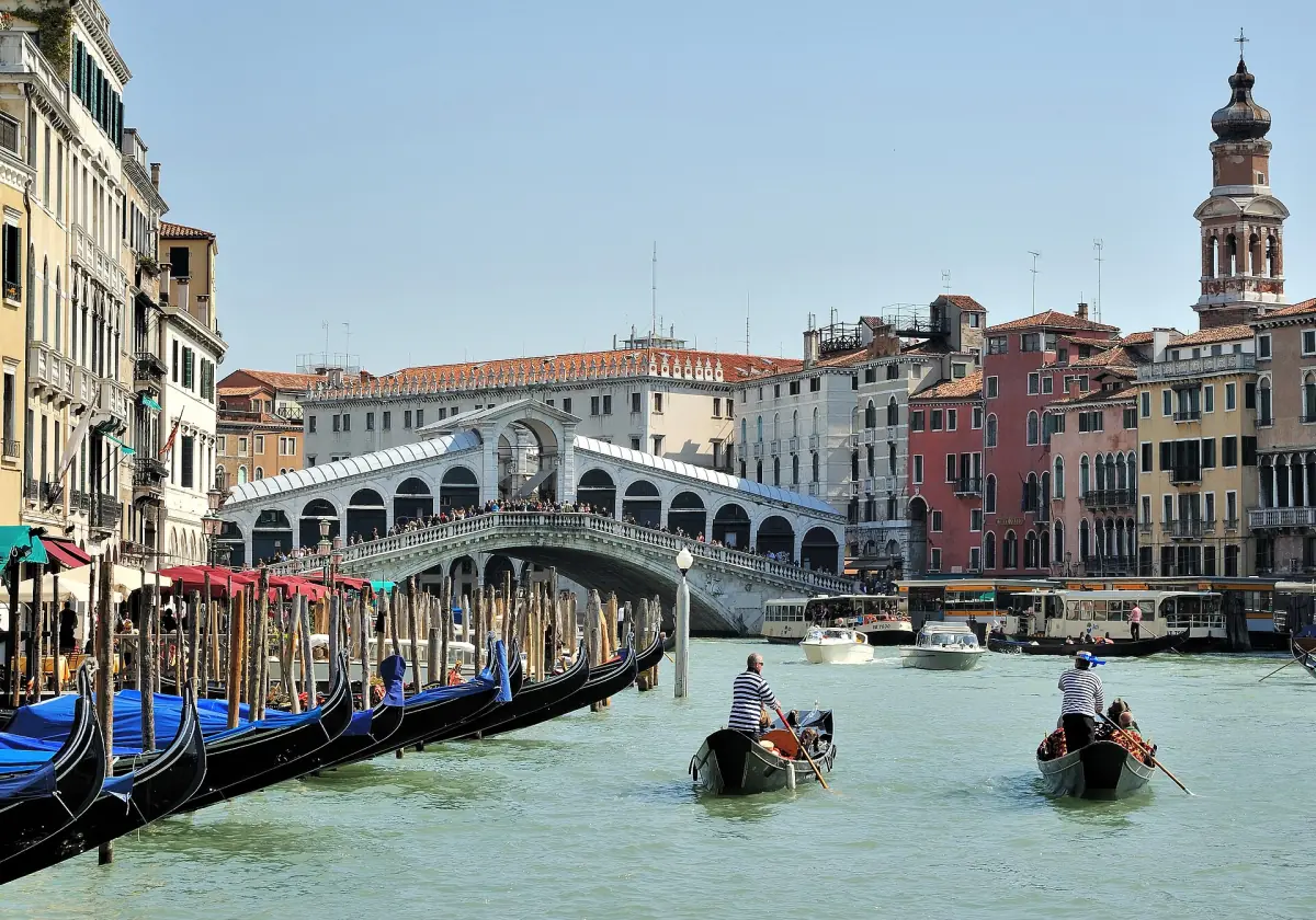 Boats with passengers on the Grand Canal below the Rialto Bridge