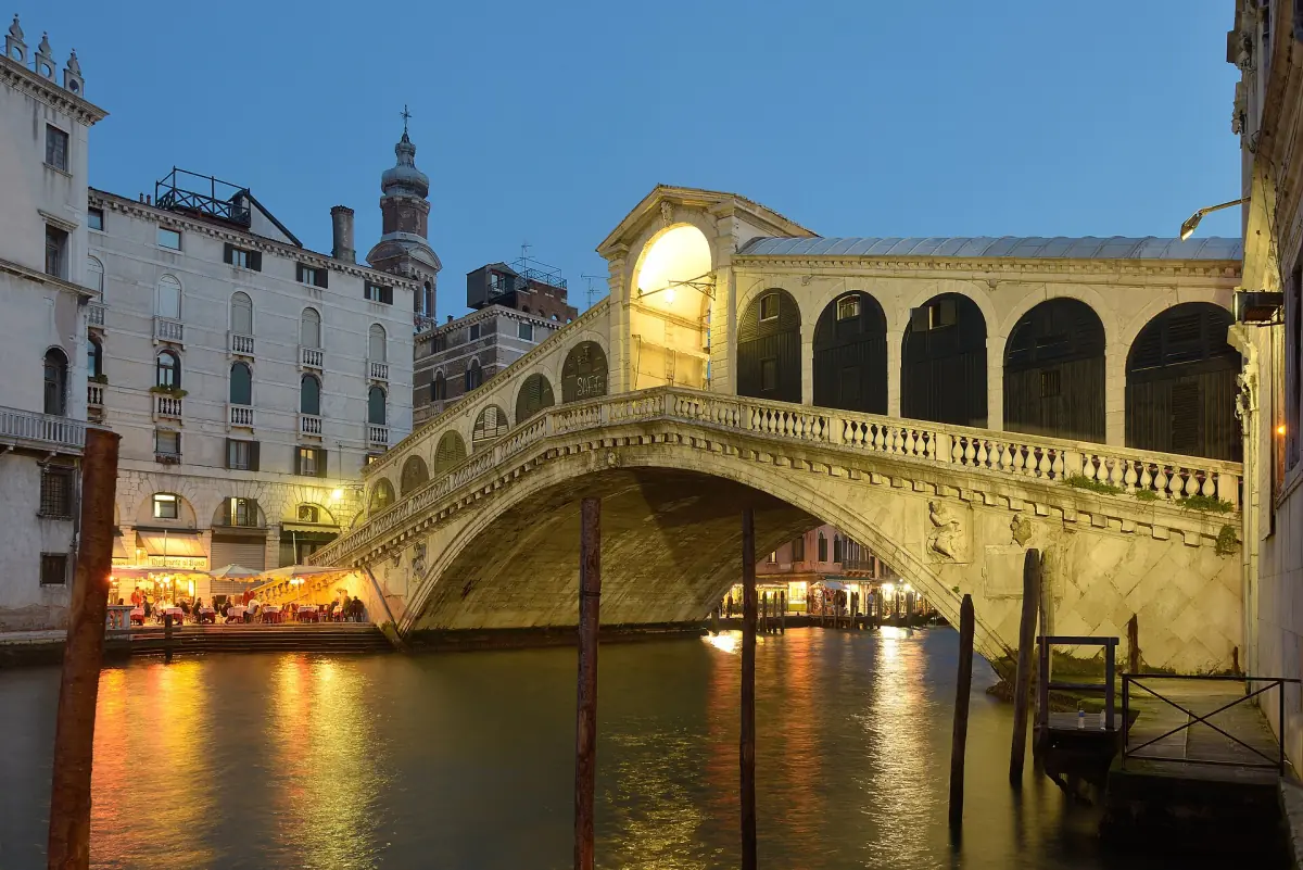 The west side of the Rialto Bridge lit in the evening